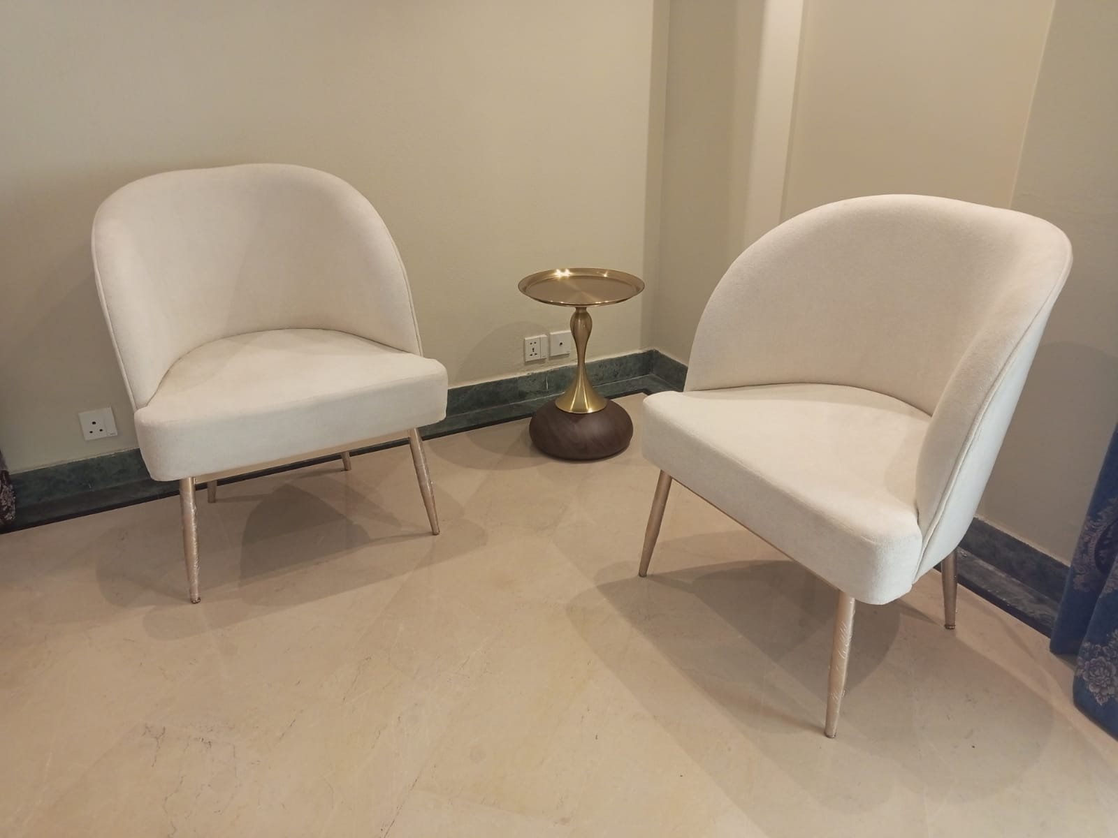 Styled furniture display with a cushioned bench and armchairs